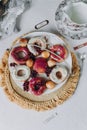 fried donut in glaze, on a plate on a white background, berry background doughnut