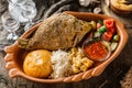 Fried dorado fish with polenta, cheese, scrabble eggs and vegetables on rustic wooden background with Russian vodka drink. Royalty Free Stock Photo