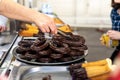 Fried dough, traditional Spanish breakfast churros bathed in chocolate, delivered by a saleswoman to a client Royalty Free Stock Photo