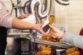 Fried dough, traditional Spanish breakfast churros bathed in chocolate, delivered by a saleswoman to a client Royalty Free Stock Photo