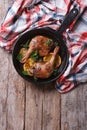 Fried duck legs with oranges, vertical top view, rustic style