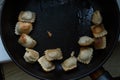 Fried dumplings in a black frying pan harmful food Royalty Free Stock Photo