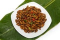 Fried edible insects on white plate and green leaf Royalty Free Stock Photo