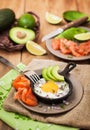 Fried egg, avocado and smoked salmon in frying pan Royalty Free Stock Photo