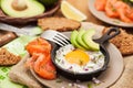 Fried egg, avocado and smoked salmon in frying pan Royalty Free Stock Photo