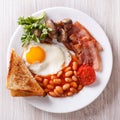 Fried egg with bacon, beans and toast top view closeup Royalty Free Stock Photo