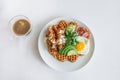 Fried egg bacon waffles fresh vegetables parsley