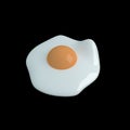 Fried egg on black background