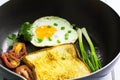Fried egg and bread in the pan placed on table Royalty Free Stock Photo