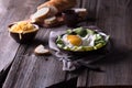 Fried egg and bread on wooden table