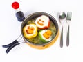 Fried egg on colorful peppers on pan Royalty Free Stock Photo