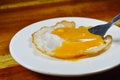 Fried egg with creamy yolk with fork