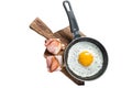 Fried egg in a frying pan with tomatoes and bacon. Isolated, white background. Royalty Free Stock Photo