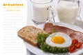 Fried egg with ham, tomatoes and fresh milk Royalty Free Stock Photo