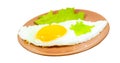 A fried egg with herbs on a saucer is isolated on a white background