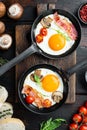 Fried Egg with ingredients in cast iron frying pan, on old dark  wooden table background, top view flat lay Royalty Free Stock Photo