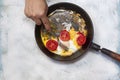Fried egg pan. Breakfast with fried eggs and vegetables Royalty Free Stock Photo