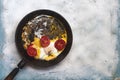 Fried egg pan. Breakfast with fried eggs and vegetables Royalty Free Stock Photo