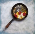 Fried egg pan. Breakfast with fried eggs and vegetables Royalty Free Stock Photo