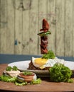 fried egg on a plate with vegetables and sauce on a wooden background Royalty Free Stock Photo