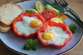 Fried egg in the ring of the bell peppers with herbs . Royalty Free Stock Photo