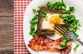 Fried egg in rye bread with bacon and parsley