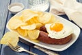 Fried egg with sausage and potato chips Royalty Free Stock Photo