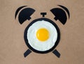 Fried egg in shape of alarm clock, breakfast time concept Royalty Free Stock Photo