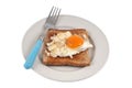 Fried egg on a slice of sandwich bread in a plate with a fork close-up on a white background Royalty Free Stock Photo