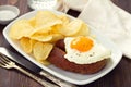 Fried egg with smoked sausage and chips Royalty Free Stock Photo