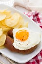 Fried egg with smoked sausage and potato chips Royalty Free Stock Photo