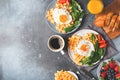 Fried egg, spinach, waffles and cup of coffee espresso, bread, baguette on dark  background Royalty Free Stock Photo