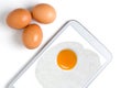 Fried egg on the tablet screen. Three eggs. White background Royalty Free Stock Photo