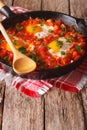 Fried egg in tomato sauce in the pan. vertical Royalty Free Stock Photo