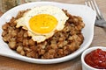 Fried egg on top of roast beef hash. Royalty Free Stock Photo