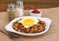 Fried egg on top of roast beef hash. Royalty Free Stock Photo