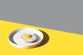 Fried egg on a white plate Color of the year 2021