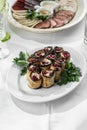 Fried eggplant slices stuffed with soft cheese and pomegranate on the table Royalty Free Stock Photo