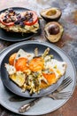 Fried eggs with asparagus, sandwich with pesto, tomatoes and mushrooms, ripe avocado. Tasty breakfast Royalty Free Stock Photo