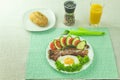 Fried eggs with bacon and fresh vegetables