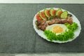 Fried eggs with bacon and fresh vegetables