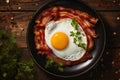 fried eggs with bacon and herbs, delicious breakfast, still life on a dark background