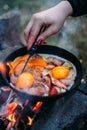 Fried eggs with bacon in a pan in the forest. Food at the camp. Fried egg with bacon on fire. Royalty Free Stock Photo