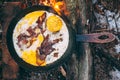 Fried eggs with bacon in a pan in the forest. Food at the camp. Fried egg with bacon on fire. Picnic Royalty Free Stock Photo