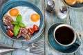 Fried eggs,  bacon, tomato, toast and a cup of coffee Royalty Free Stock Photo