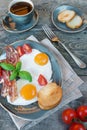 Fried eggs, bacon, tomato, toast and a cup of coffee Royalty Free Stock Photo