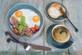 Fried eggs,  bacon, tomato, toast and a cup of coffee Royalty Free Stock Photo