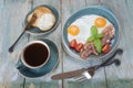 Fried eggs, bacon, tomato, toast and a cup of coffee Royalty Free Stock Photo