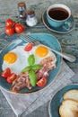 Fried eggs, bacon, tomato, toast and a cup of coffee Royalty Free Stock Photo