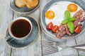 Fried eggs, bacon, tomato, toast and a cup of coffee Royalty Free Stock Photo